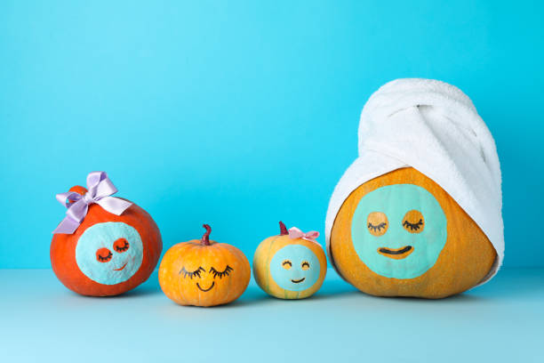 istock Funny pumpkins on blue background. Body care 1178963417