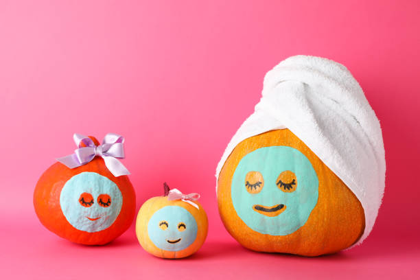 istock Funny pumpkins on pink background. Body care 1178963472