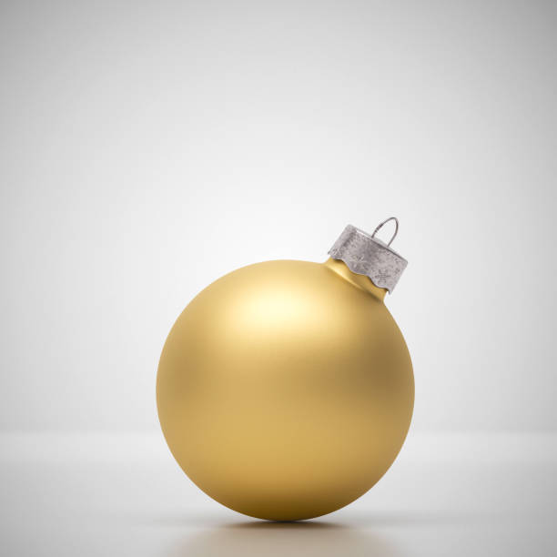 istock Matte gold crimson Christmas bauble on light grey 1178963529