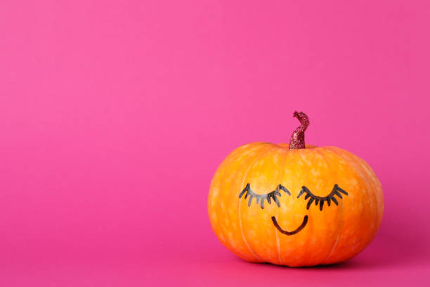 istock Pumpkin with smile on pink background, space for text 1178963577