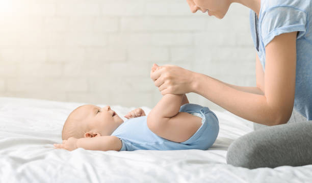 istock Caring mother making strenghtening exercises with her newborn son 1178964374
