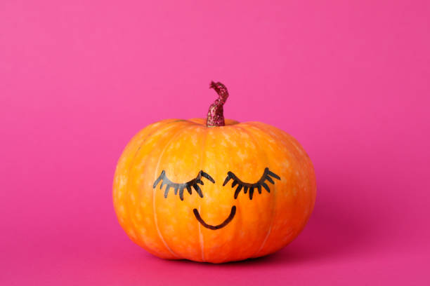 istock Pumpkin with smile on pink background, space for text 1178964376