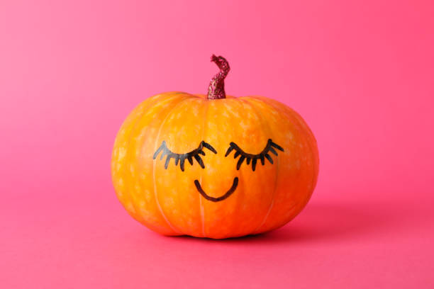 istock Pumpkin with smile on pink background, space for text 1178964448