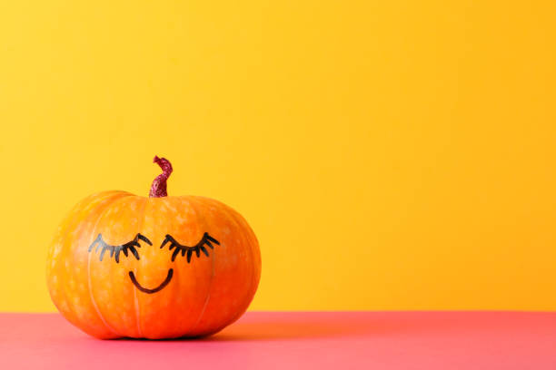 istock Pumpkin with smile against yellow background, space for text 1178964483