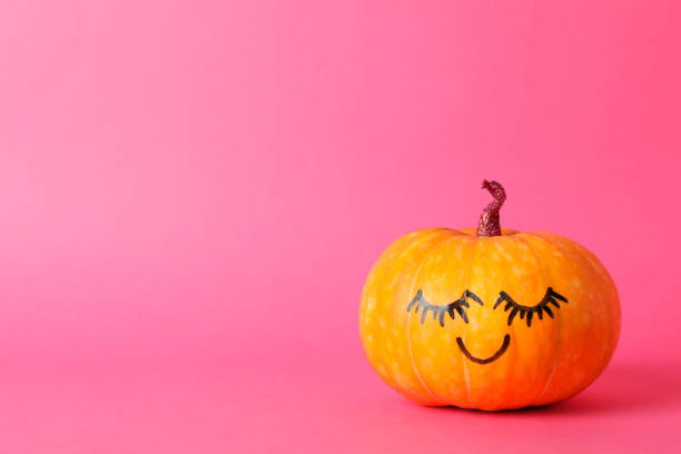 istock Pumpkin with smile on pink background, space for text 1178964523