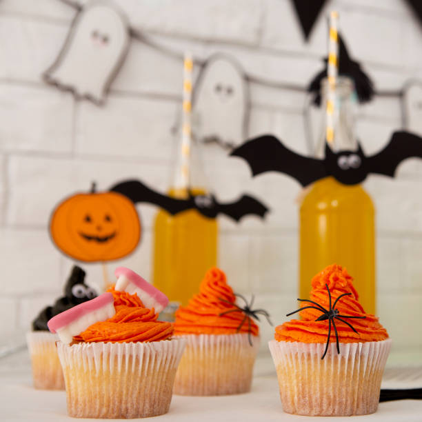 istock Halloween stylized yellow cocktails and cup cakes 1178965063