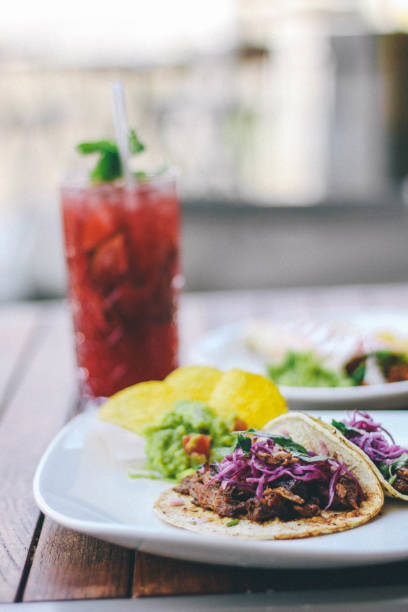 Tacos and cocktail on a wooden table