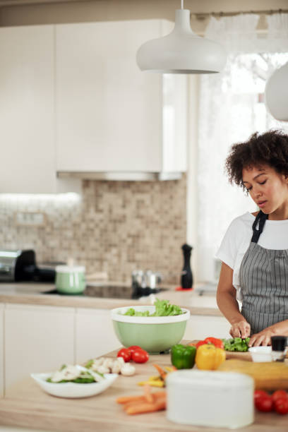 istock Woman chopping lettuce. 1178972825