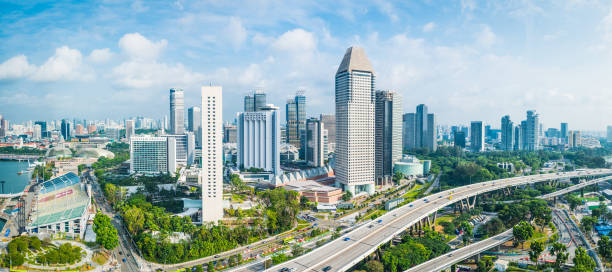 Aerial panorama over highrise highways skyscraper cityscape Marina Bay Singapore Aerial panorama over the towering skyscrapers and busy highways of downtown Singapore surrounding Marina Bay. singapore city stock pictures, royalty-free photos & images