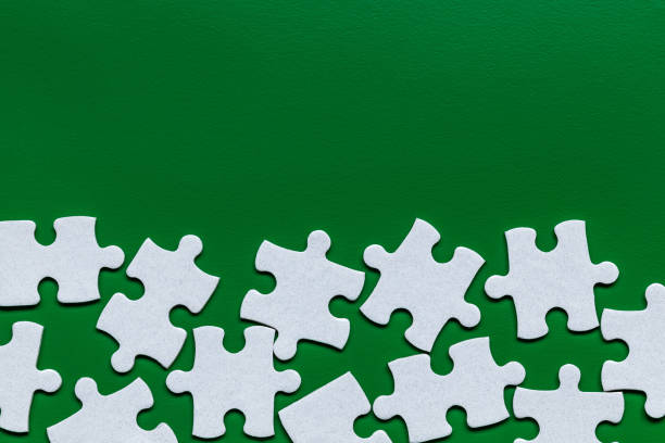 istock White jigsaw puzzle. White puzzle pieces on color background. Unfinished white jigsaw puzzle pieces on color background. 1178974529