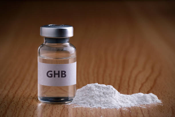 bottle of ghb with drug powder on wooden background.ghb - alcohol drug abuse alcoholism pill imagens e fotografias de stock