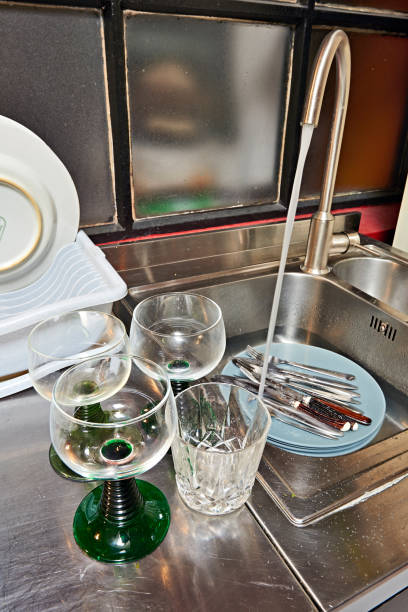 istock Dirty plates and cutlery in kitchen sink before washing 1178979855