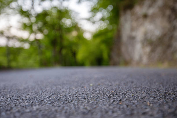istock Road from the ground level with green bokeh background 1178981207