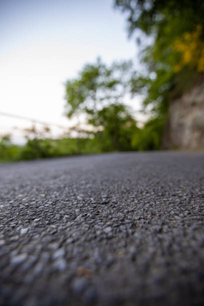 istock Road from the ground level with green bokeh background 1178981211