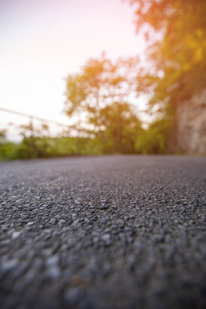 istock Road from the ground level with green bokeh background 1178981218