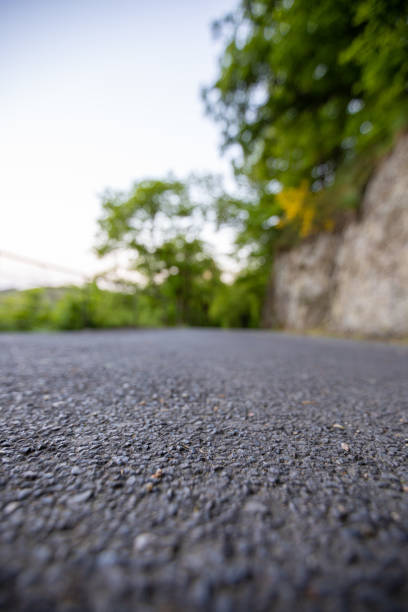 istock Road from the ground level with green bokeh background 1178981220