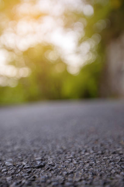 istock Road from the ground level with green bokeh background 1178981248