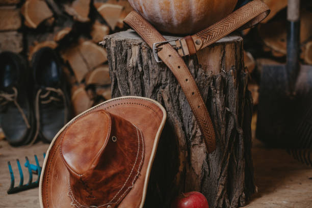 istock Leather hat rests on stump. Belt lies on top 1178981267