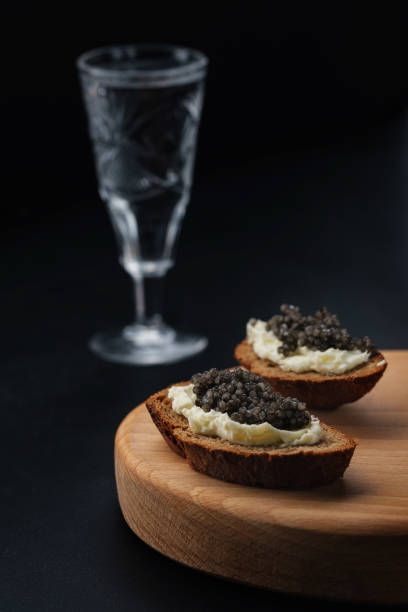 istock Sandwich with black caviar on black background 1178981375