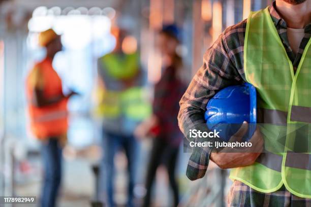 Man Holding Blue Helmet Close Up Stock Photo - Download Image Now - Occupation, Safety, Construction Industry