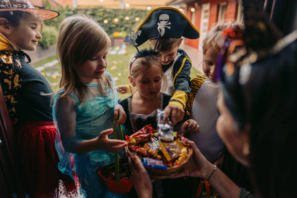 Trick or treating Group of kids trick or treating trick or treat photos stock pictures, royalty-free photos & images