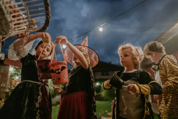 Group of cute kids trick or treating