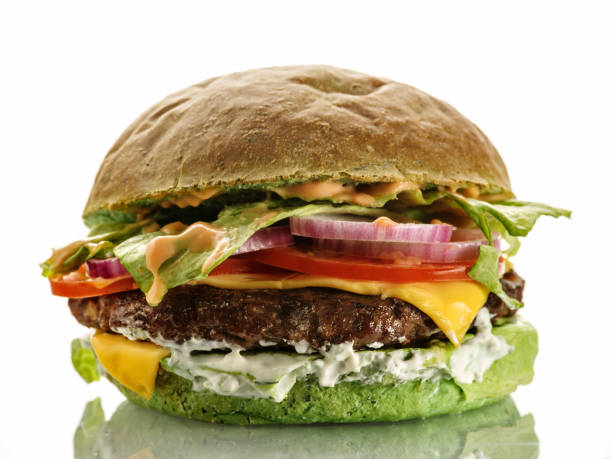 istock Fresh homemade delicious burger with a spinach bun. Isolated on white 1178984926