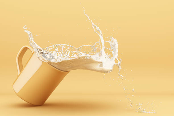 istock Pouring milk into a cup, milk splashing in yellow cup.3d rendering. 1178985135