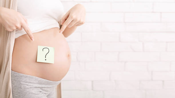 istock Pregnant woman belly with question mark, panorama 1178985587