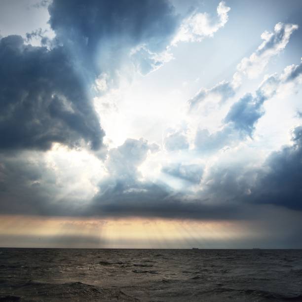 istock Sunset in a cloudy sky over open Baltic sea with veri distant ship silhouettes. 1178986630