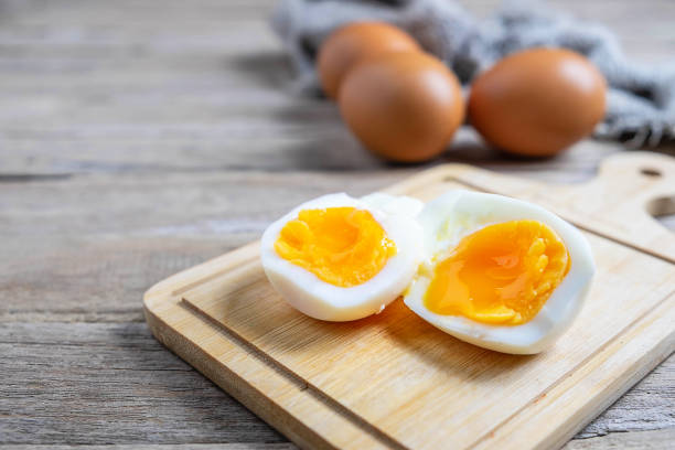 istock Boiled eggs and raw eggs on a wooden table 1178986691