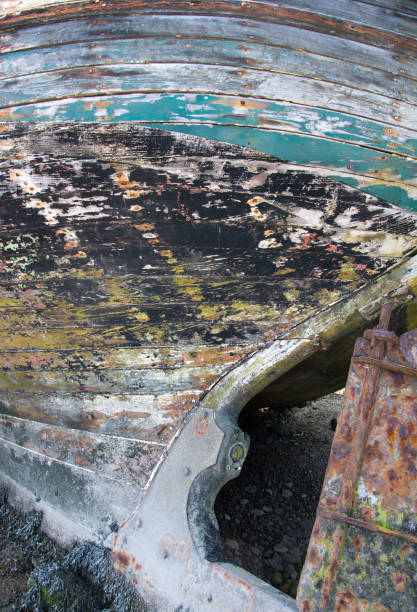istock Weathered Painted Hull and Rusted Rudder on Wrecked Boat 1178987318