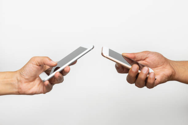 istock Two Hands Holding Mobile Phones 1178987469