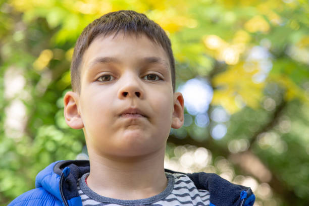 istock Boy looking into the camera with question in his eyes. 1178988471