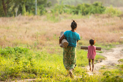 Mae Sot, Tak, Thailand - October 01, 2019 : Unidentified Myanmar woman with daughter carrying firewood together a Mae Sot, Tak, Thailand.