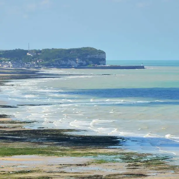 Photo of White cliffs and a beach during low tide in Veules les Roses, France