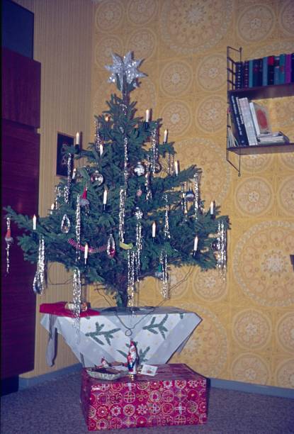 istock Christmas tree in front of yellow wallpaper 1178996200