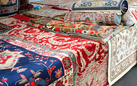 market stall specializing in the sale of precious handmade oriental rugs