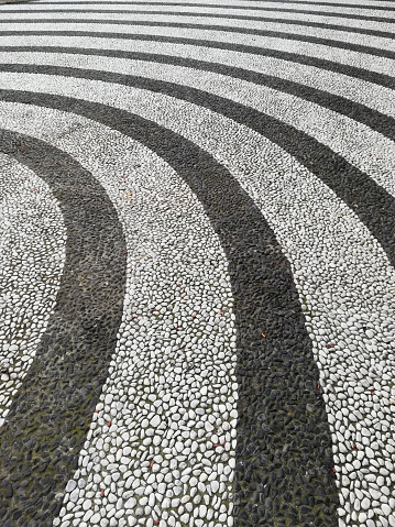 pavement floor stripes black and white stones