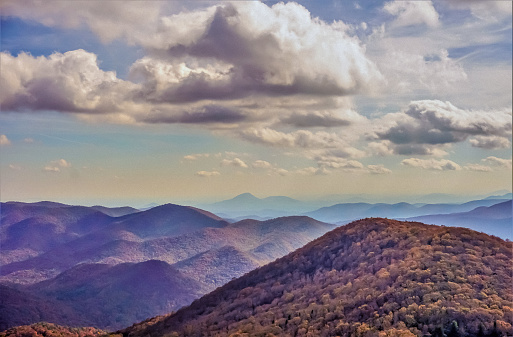 The fantastic view from Brasstown Bald mountain ( the highest mountain in Georgia) colorful in Fall season with white fluffy clouds and blue sky, North Georgia in USA.