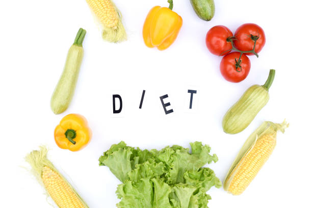 istock Flat lay on an isolated white background with vegetables and the inscription diet. 1179003314