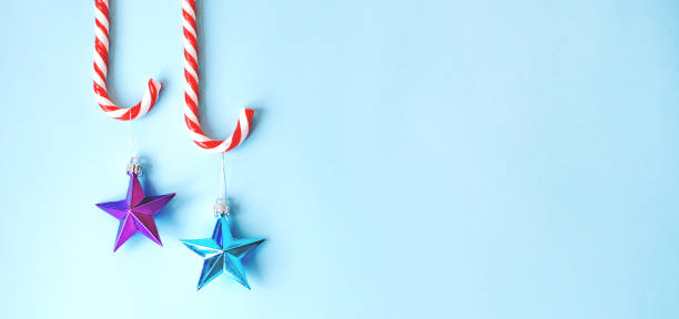 istock Two candy canes with toys on the Christmas tree. 1179003873