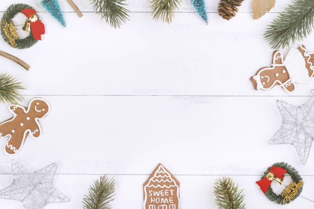 istock Christmas concept composition decoration objects, fir tree branch wreath, gingerbread man biscuit isolated on white wooden table. 1179004028