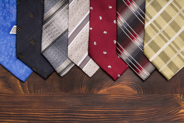 istock Many multi-colored ties in a row on a dark background . copy space 1179004294