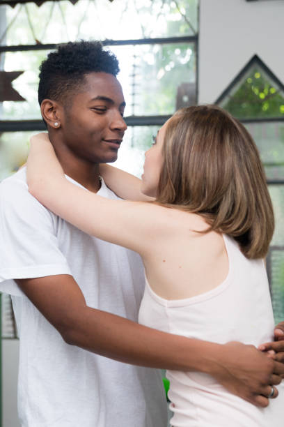 istock Lovely young beautiful interracial couple hugging expressing love 1179004516