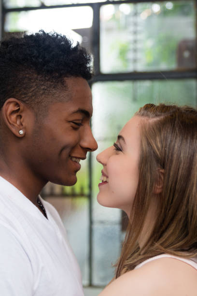 istock Lovely young beautiful interracial couple expressing love 1179005137