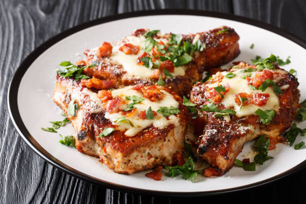 istock Tasty pork chops with melted parmesan and bacon closeup on a plate. horizontal 1179005416