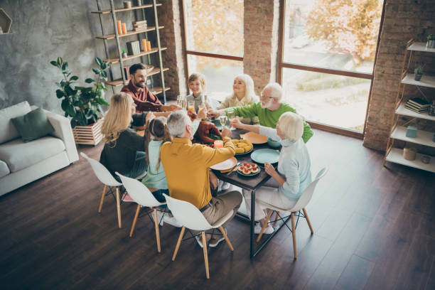 top above high angle photo of happy large family gathering around table senior retired pensioner small little kids hold glass juice alcohol toast sit table enjoy thanksgiving november event in house - smiling little girls little boys autumn imagens e fotografias de stock