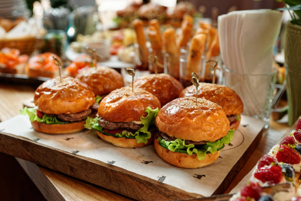 istock Burgers and another food on restaurant table 1179007225
