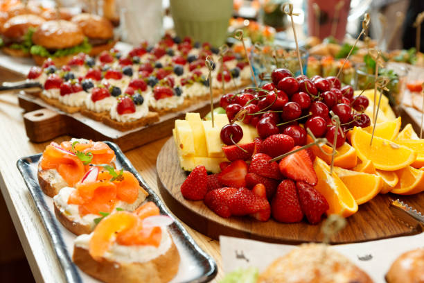 istock Fruits, fish snacks and dessert on catering table 1179007235